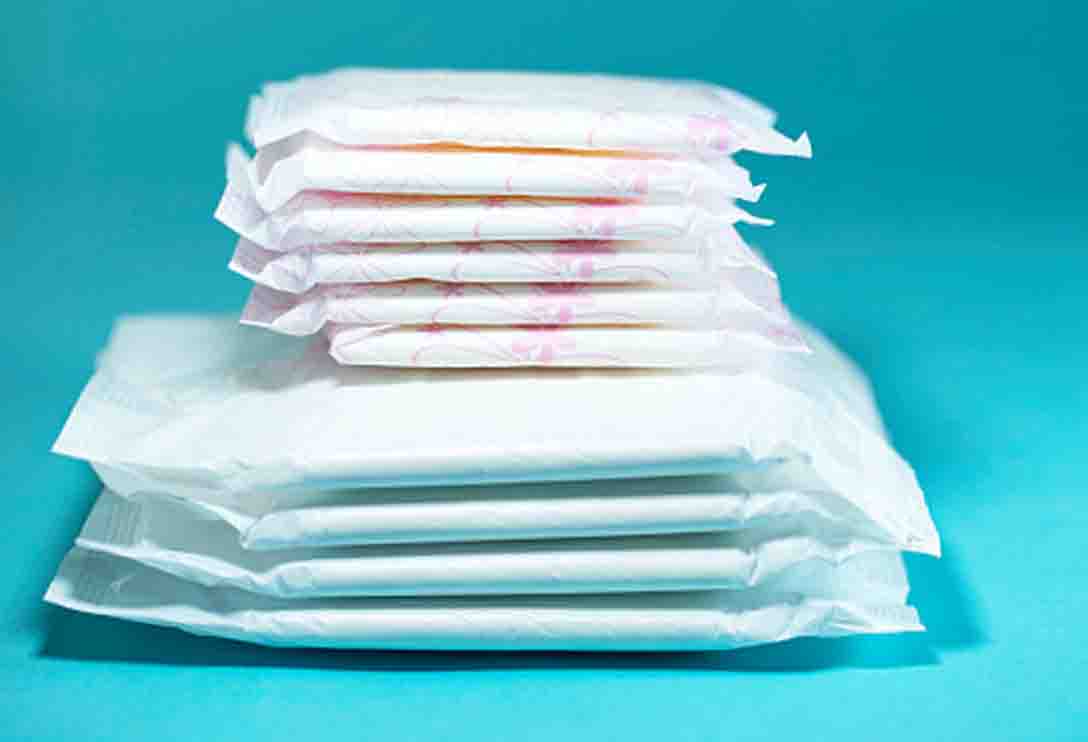 Sanitary pads and absorbent sheets on blue background