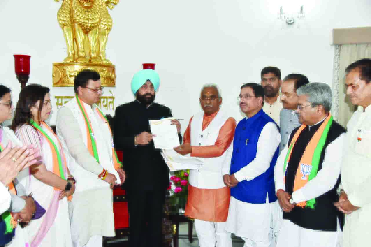 Dhami meets governor, stakes claim to form new government