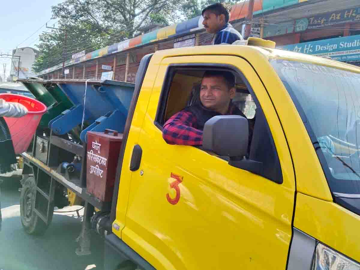 Municipal commissioner drives garbage collection vehicle