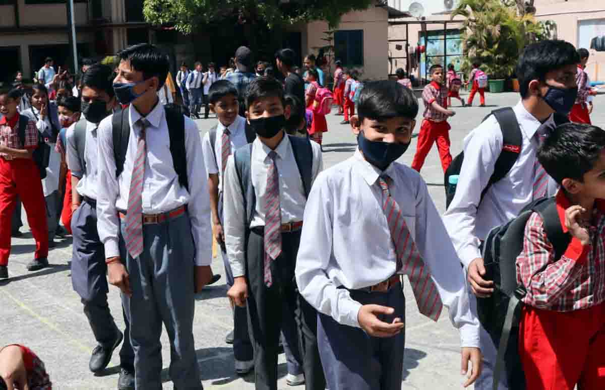 Students don masks at a school in Dehradun amidst rise in number of Covid-19 cases in the district