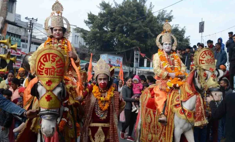 Locals view a Ram Barat taken out in Dehradun on Monday