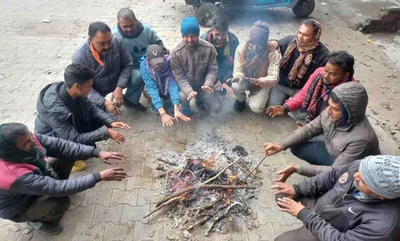 Men seek relief from the cold around a fire in Rishikesh on Friday